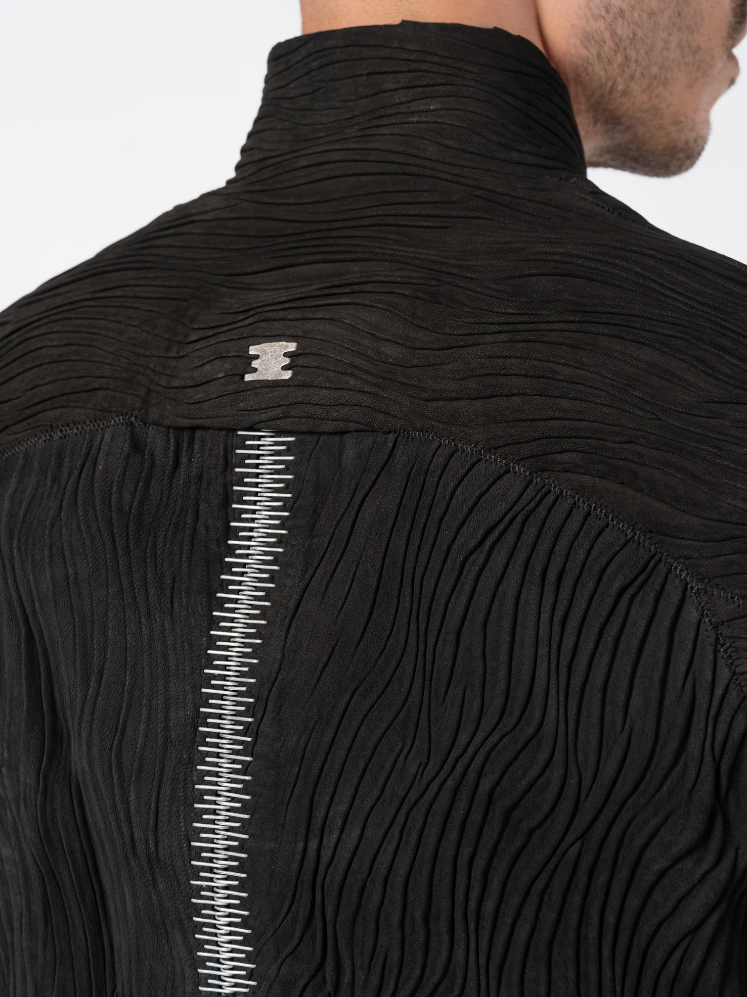 ISAAC SELLAM Wavy Pleated Leather Spine Jacket, back zipper close-up