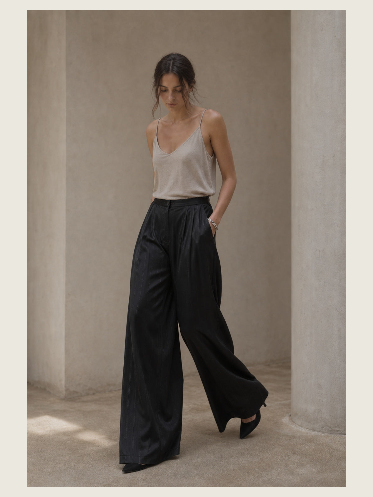 תמונת אווירה עריכתית של INN7 בסביבת טיח עבור Pinstripe Satin Palazzo Trousers — LA HAINE INSIDE US